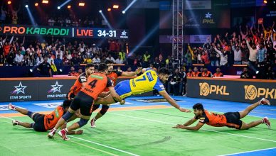 Pro Kabaddi League player performing raid in front of packed stadium