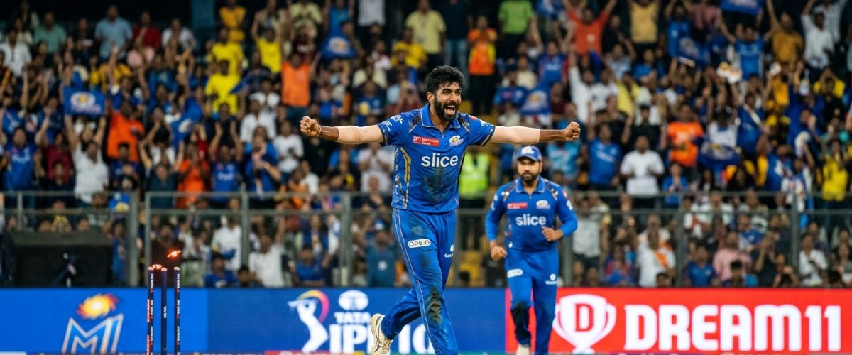 Indian cricket bowler celebrating wicket at packed IPL stadium under floodlights