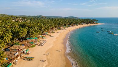 Serene Goa beach in April off-season with golden sand and calm turquoise Arabian Sea