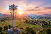Modern telecom tower with 5G antenna arrays against sunrise sky in Indian landscape