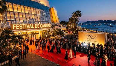 The iconic Cannes Film Festival red carpet and Palais des Festivals building at dusk