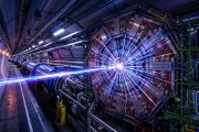 CERN Large Hadron Collider tunnel with particle collision visualization and blue energy beams