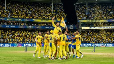 Cricket stadium during an IPL night match with floodlights and packed crowd