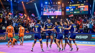 Pro Kabaddi League match action in a packed indoor stadium with team celebrating