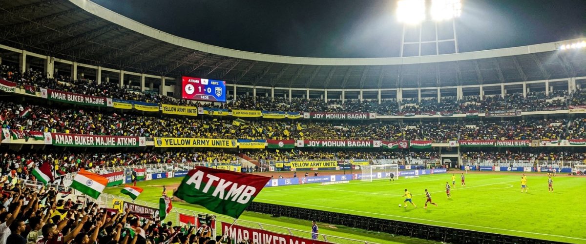 Indian football stadium at night with floodlights and packed crowd during ISL match