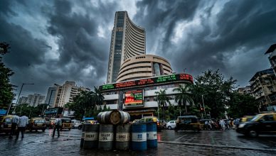 Bombay Stock Exchange building with digital stock ticker displays showing market volatility