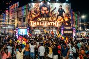 South Indian cinema poster display with packed movie theater entrance and colorful lights