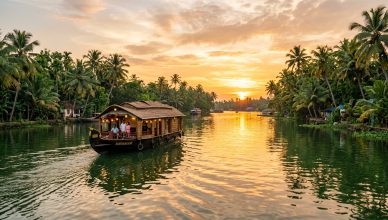 Traditional Kerala houseboat on calm backwaters surrounded by palm trees at golden sunset