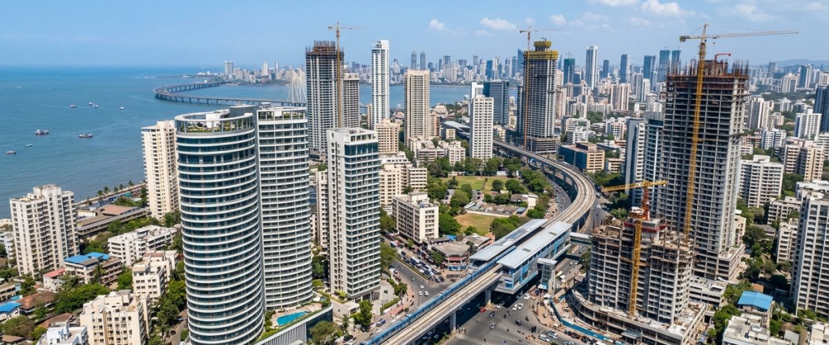 Aerial view of Mumbai skyline with modern residential towers and metro rail line