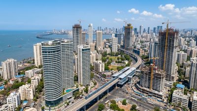 Aerial view of Mumbai skyline with modern residential towers and metro rail line