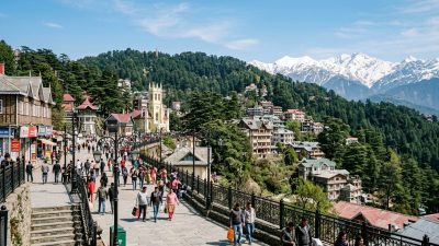 Shimla Mall Road in April with tourists and colonial buildings against Himalayan backdrop