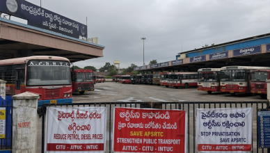 Empty Telangana bus terminal with idle state transport buses and protest banners during RTC strike