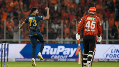 IPL cricket match at packed Narendra Modi Stadium under floodlights with Gujarat Titans vs Sunrisers Hyderabad